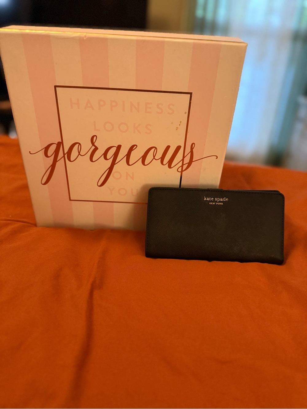 kate spade black saffiano zip-around wallet with gold logo